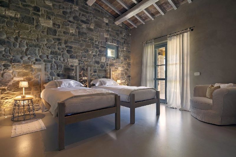 Camera da letto con muro in pietra